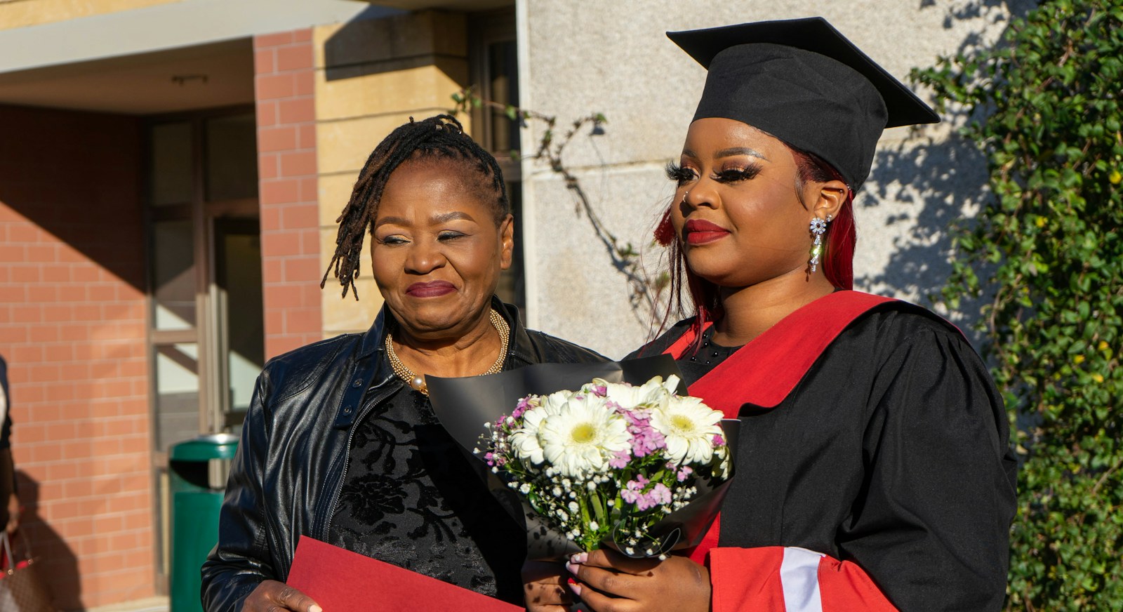 Graduate holding flowers