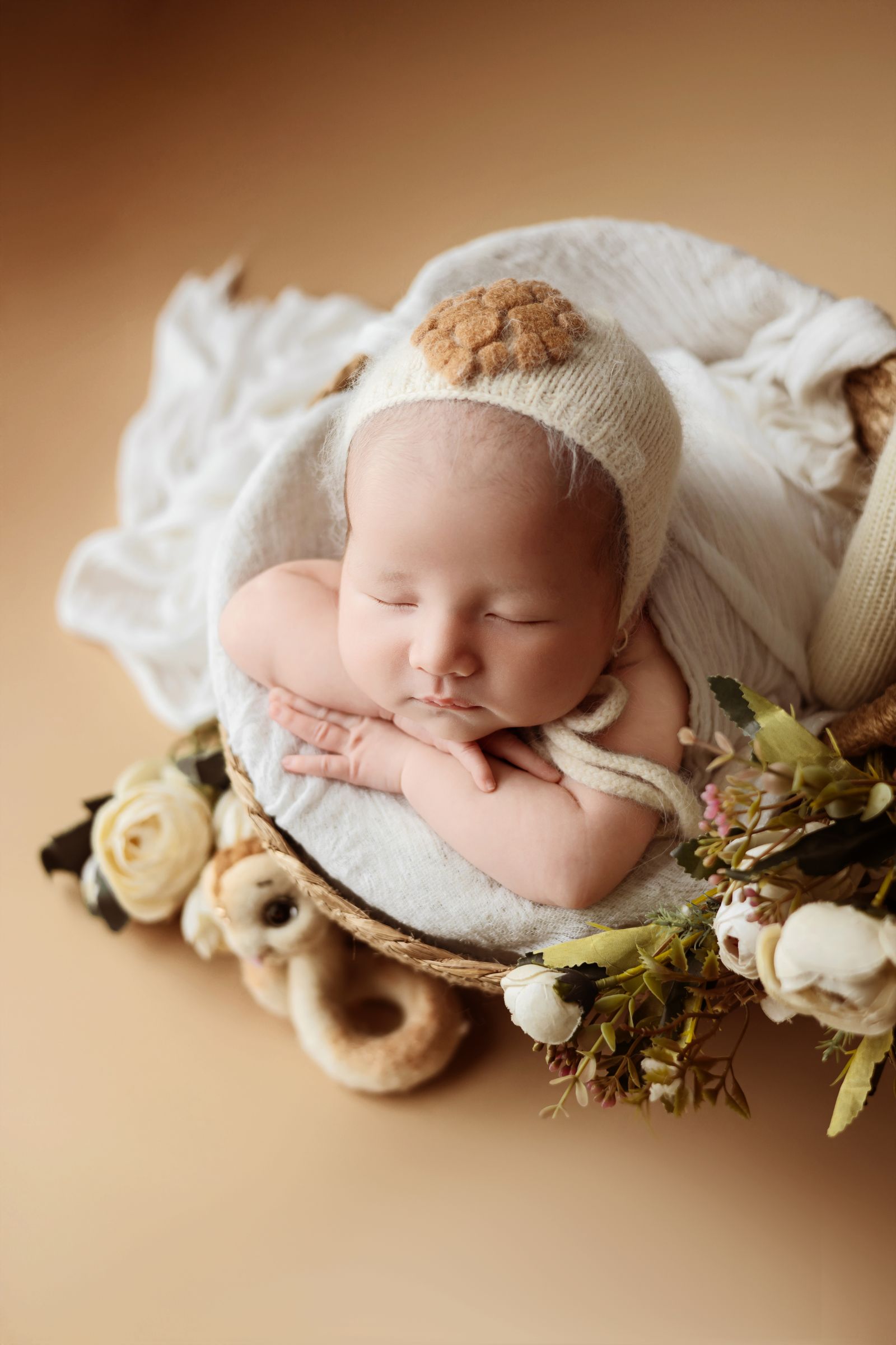Newborn baby sleeping among flowers