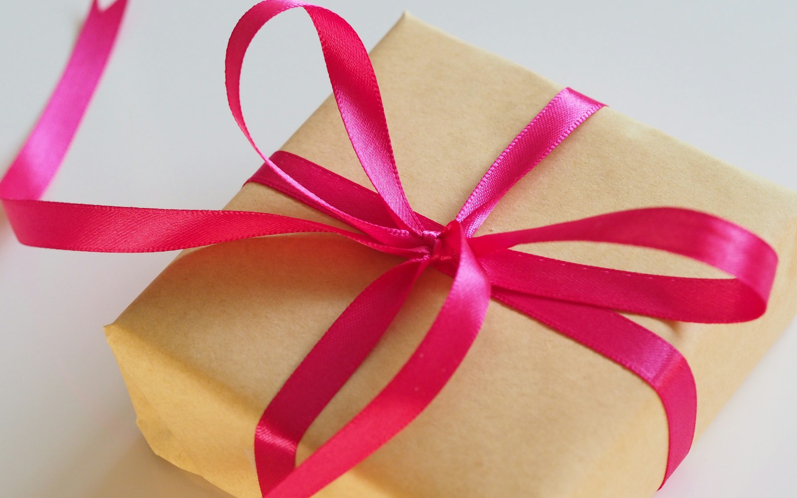 A carefully wrapped gift box with ribbon